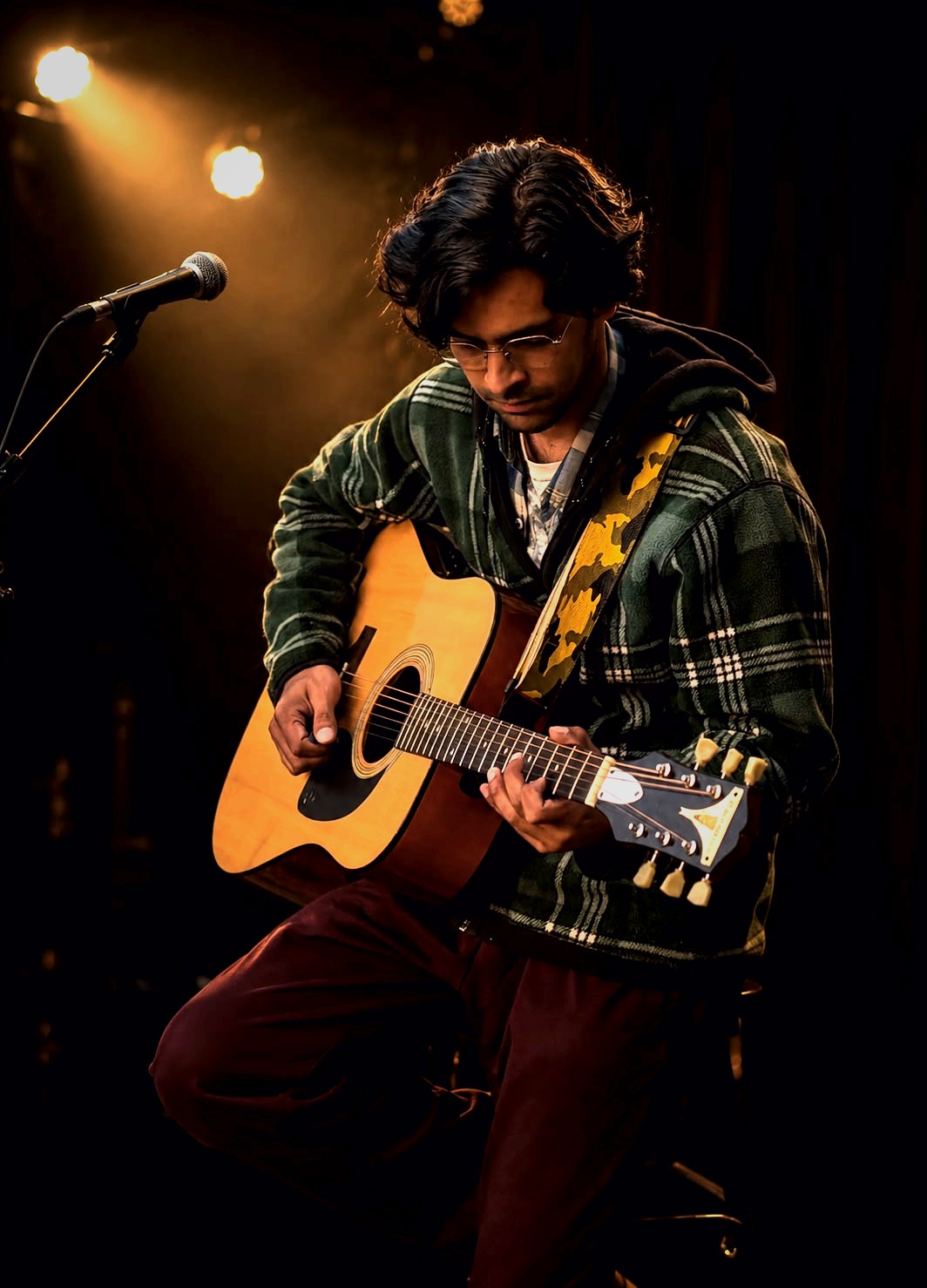 Student practising acoustic guitar
