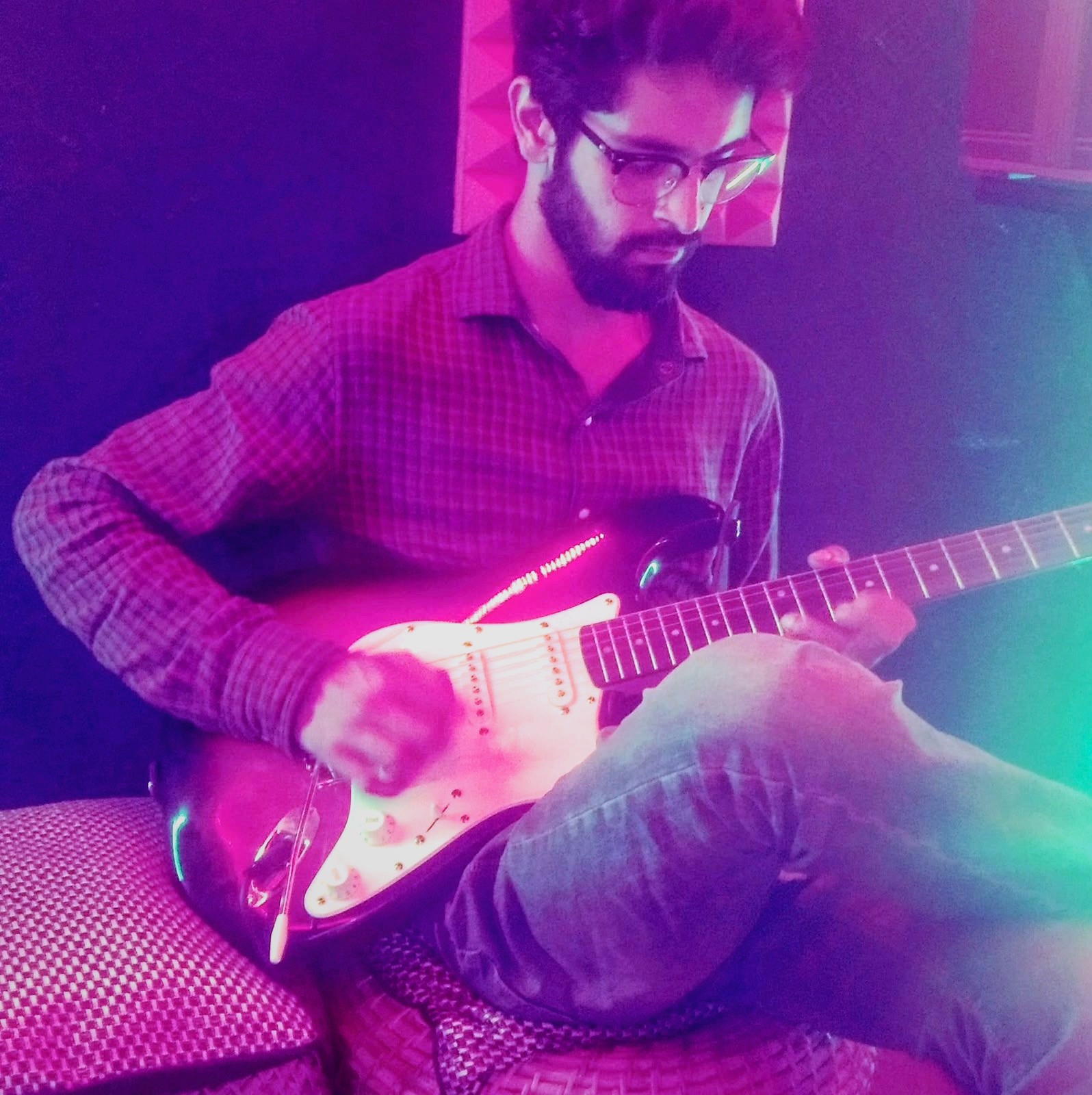 Student practising on an electric guitar